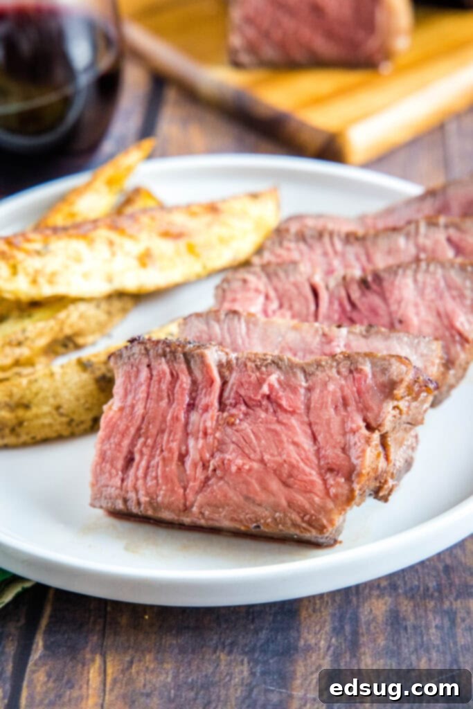 Sous Vide Steak Perfection 7 beautifully sliced sous vide steak presented on a plate, garnished and ready to be enjoyed