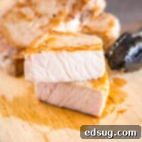 Effortlessly Perfect Sous Vide Pork Chops 11 cropped picture of pork chop on cutting board