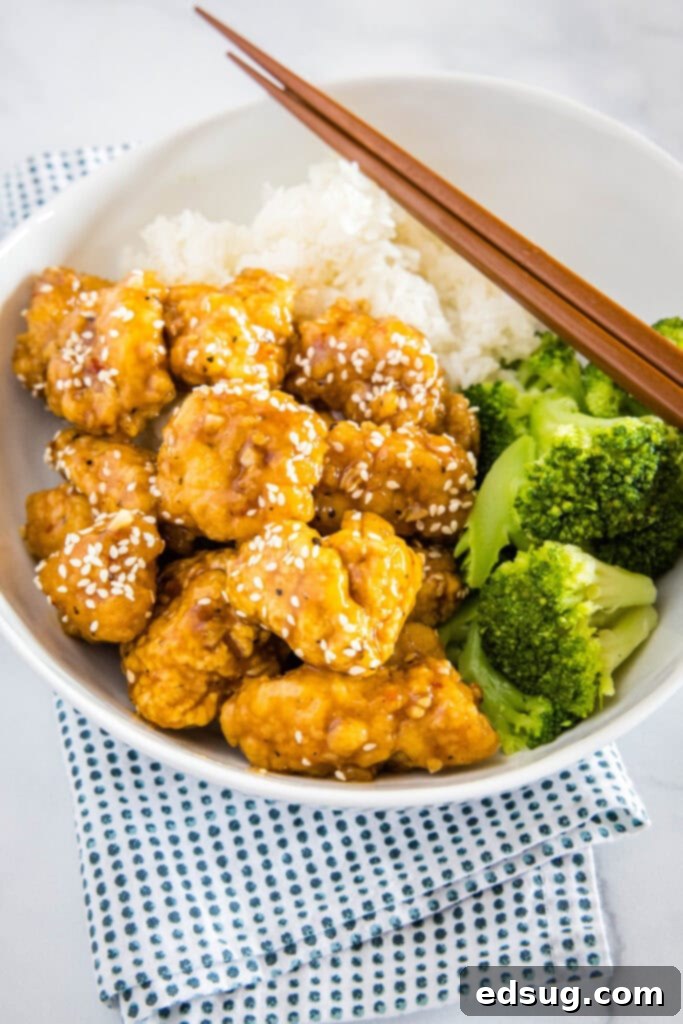 Effortless Sesame Chicken 2 Crispy sesame chicken served with vibrant green broccoli and fluffy white rice, ready to be enjoyed.