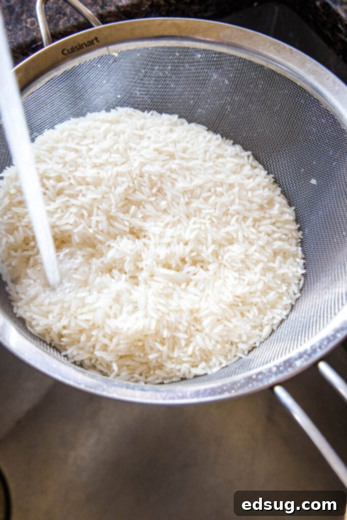 Perfect Instant Pot Jasmine Rice 3 rinsing white rice in the sink, a crucial step for perfect Instant Pot Jasmine Rice