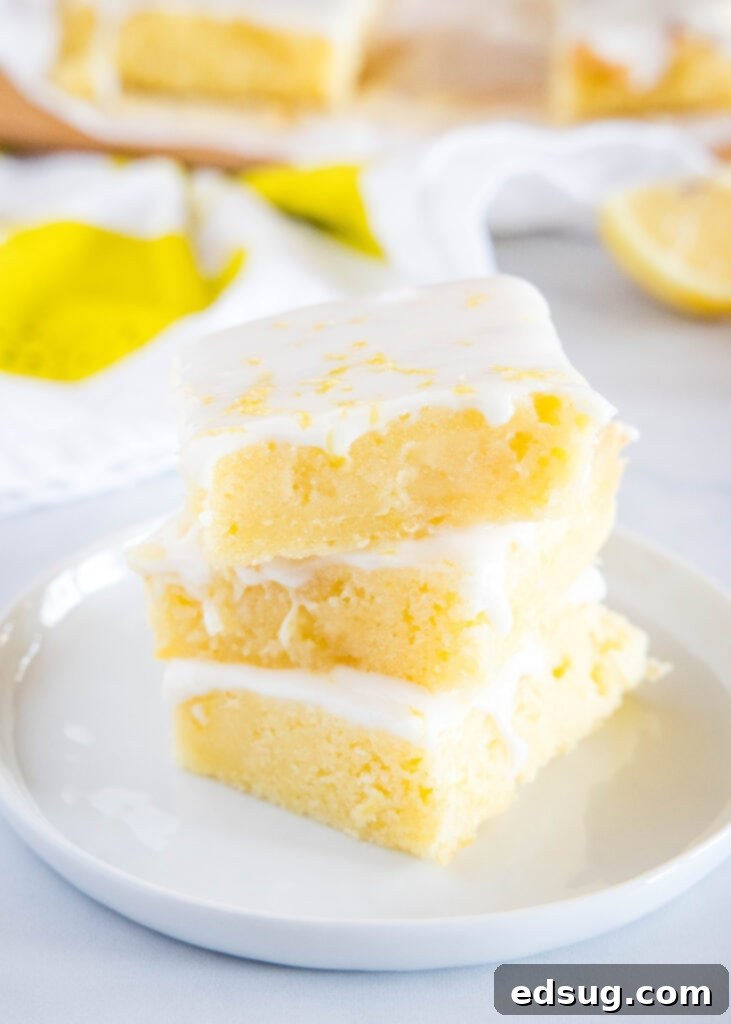 Sunshine Lemon Brownies 5 lemon blondies stacked on white plate