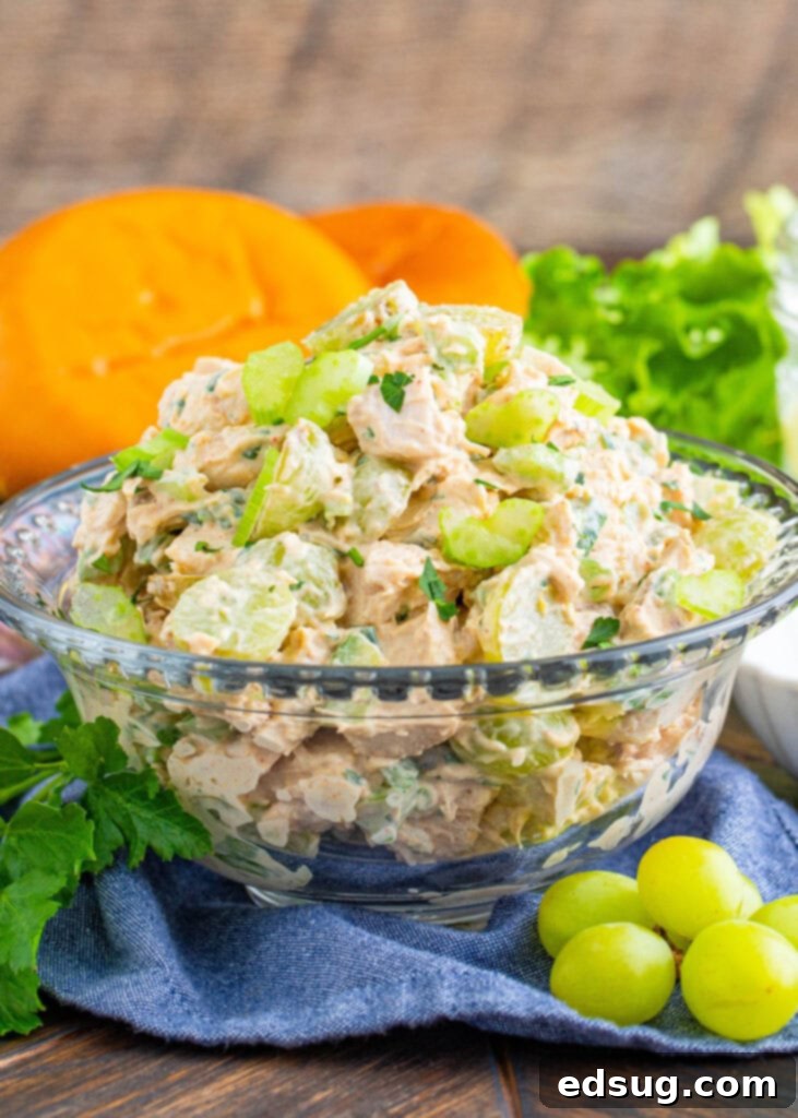 A large serving bowl filled with creamy chicken salad with grapes, ready to be enjoyed.