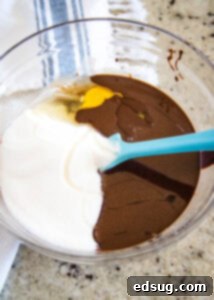 Colorful M and M Brownies 8 Mixing eggs and sugar into brownie batter