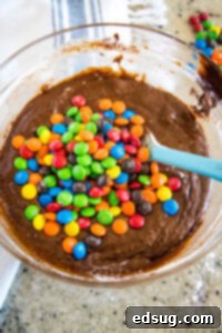 Colorful M and M Brownies 10 adding M&Ms to brownie batter