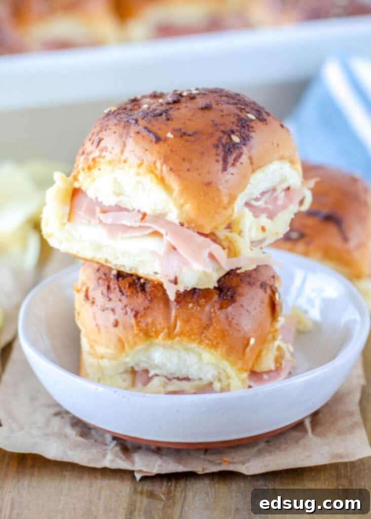 ham and cheese sliders stacked on a plate