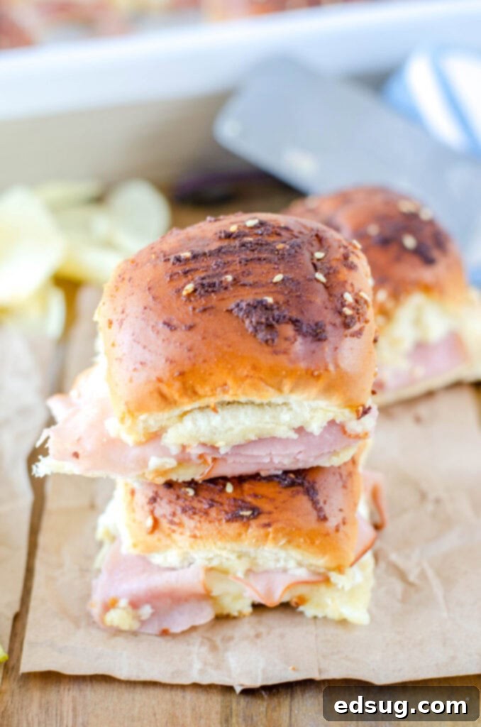 ham and swiss sliders stacked on board