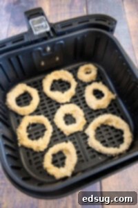 Crispy Air Fryer Onion Rings 12 Onion rings placed in an air fryer basket