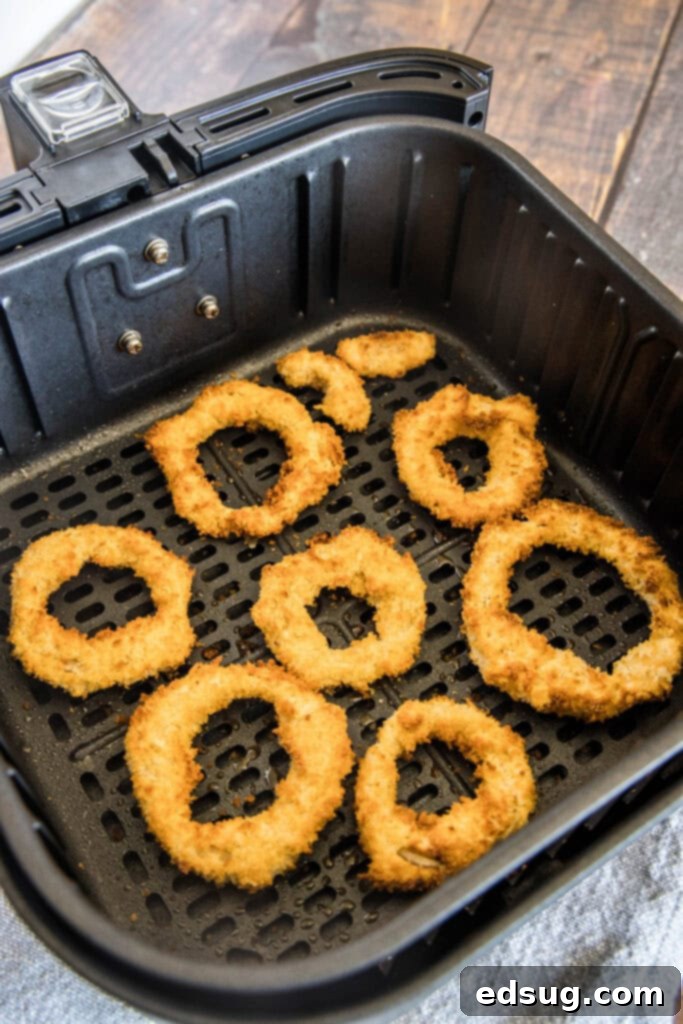 Crispy Air Fryer Onion Rings 5 Freshly air-fried onion rings piled high in an air fryer basket.