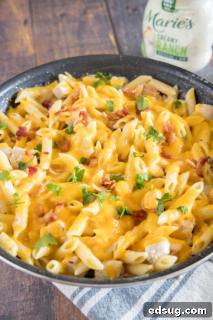 Creamy Chicken Bacon Ranch Pasta 6 Skillet of creamy Chicken Bacon Ranch Pasta on a rustic wooden table