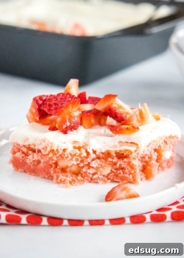 strawberry brownie with bite taken out of it on a plate