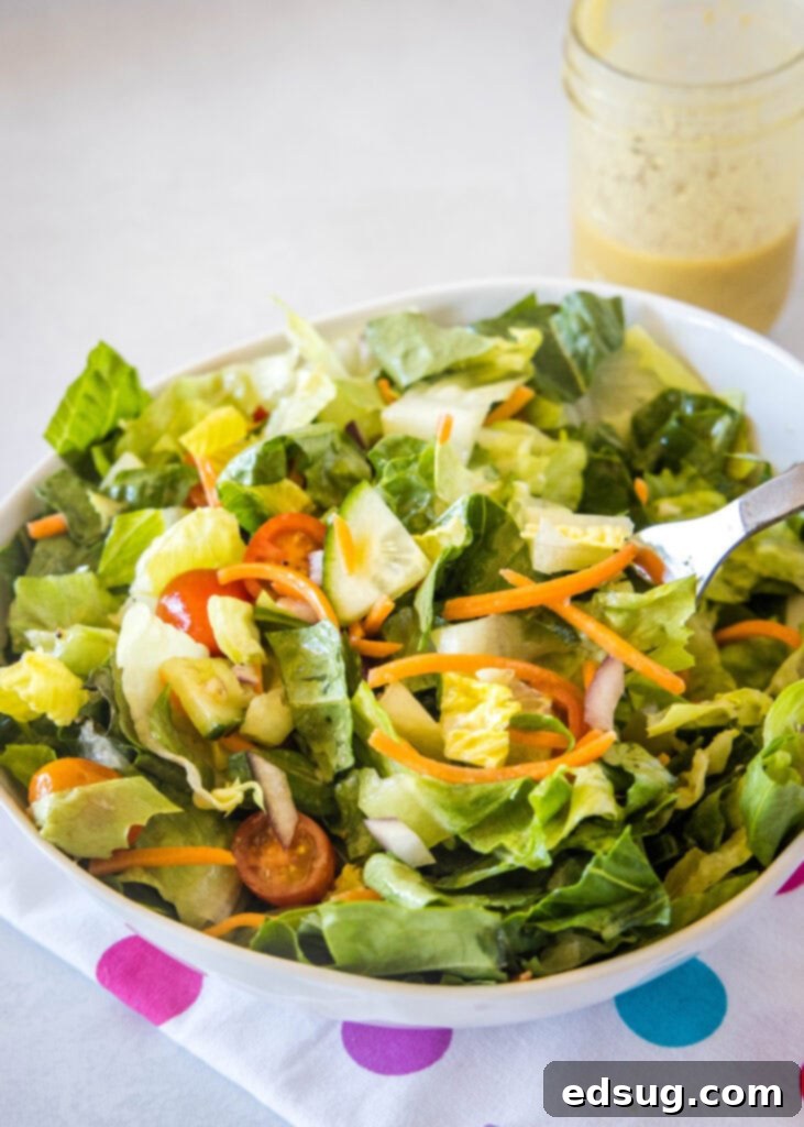 A vibrant simple tossed salad with fresh greens and various colorful vegetables, ready to be served as a healthy side dish.