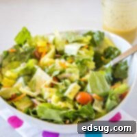 Close up of a vibrant simple tossed salad in a white bowl, ready to be enjoyed as a healthy meal.