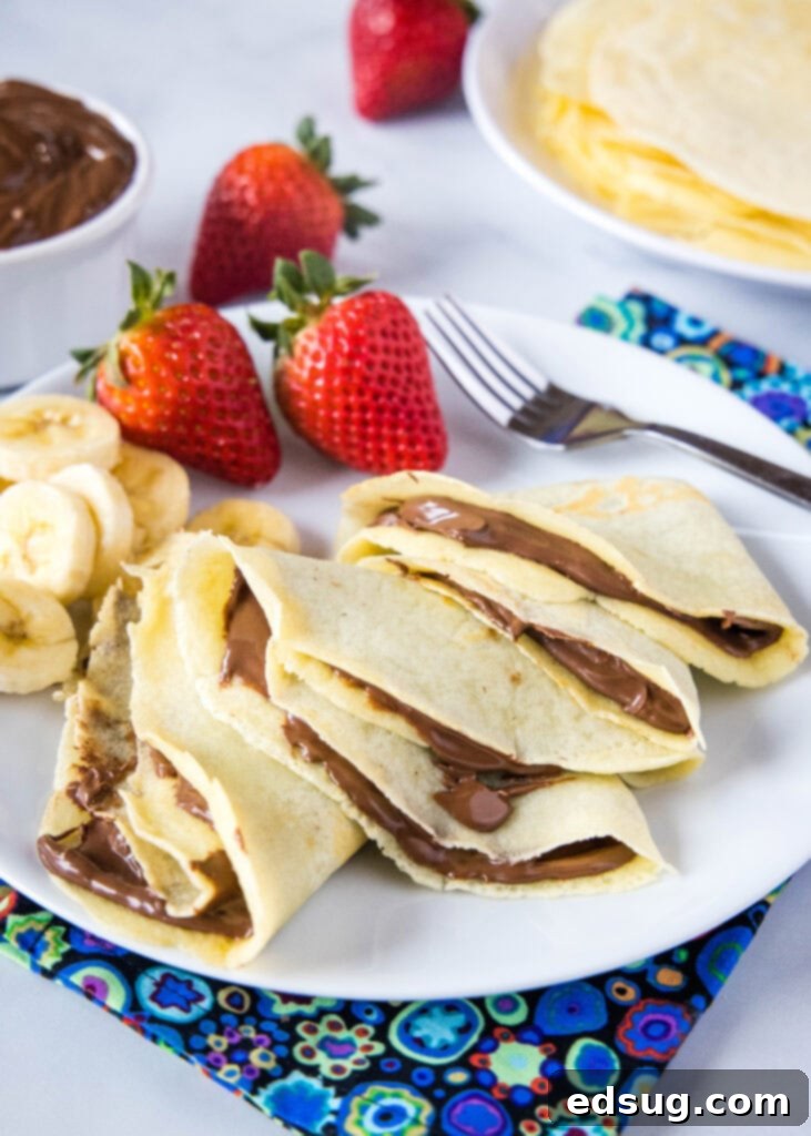 crepes filled with nutella and sliced bananas on a plate