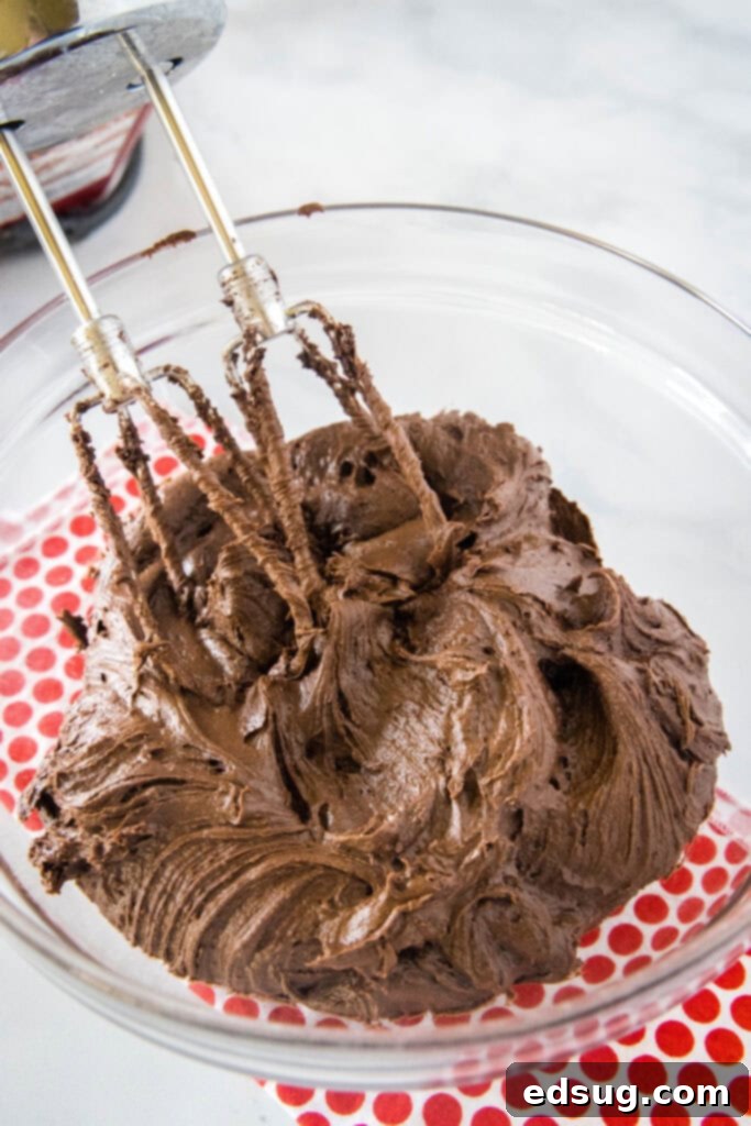 No-Fuss Chocolate Frosting 4 hand mixer making chocolate frosting in a bowl