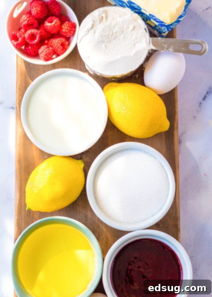 ingredients laid out on a counter to make lemon cupcakes, including flour, butter, eggs, and fresh lemons