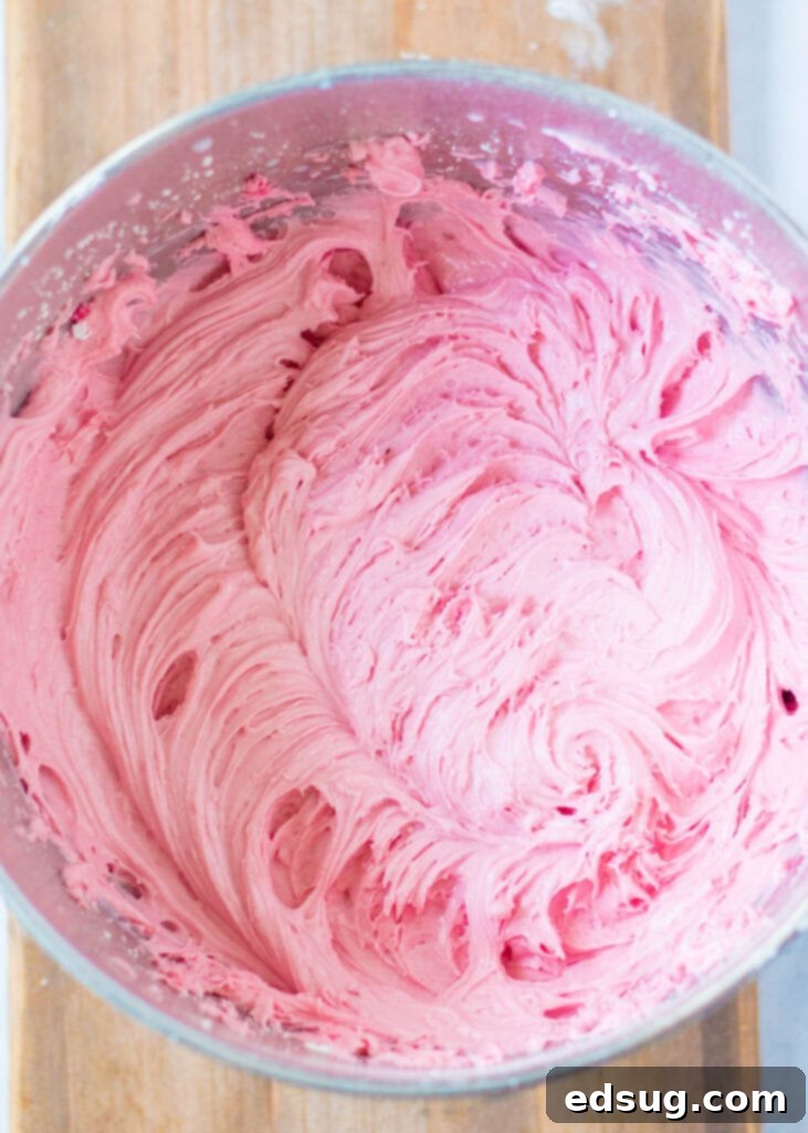 raspberry frosting in a mixing bowl, ready for piping