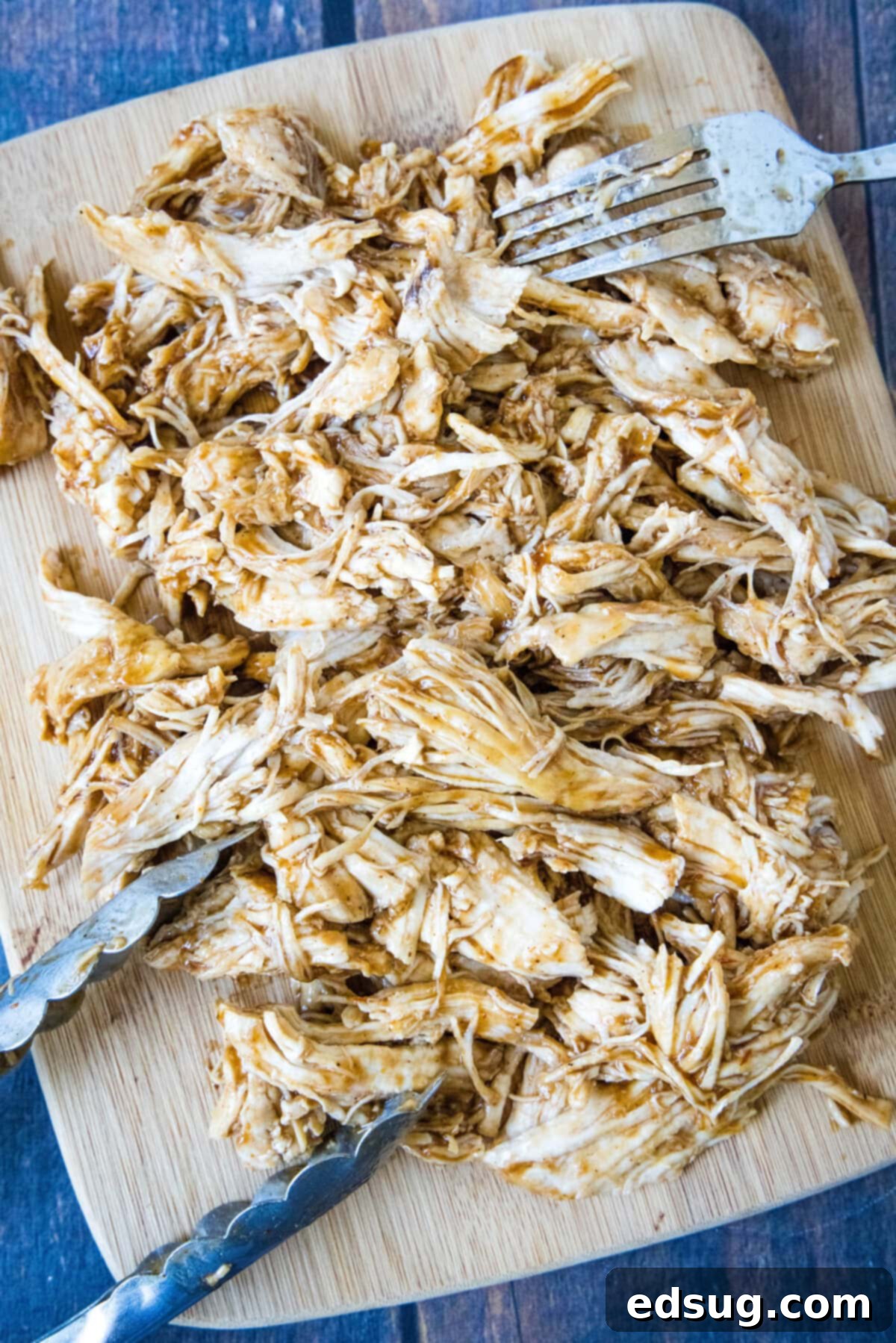 Effortless Instant Pot BBQ Chicken 6 shredded bbq chicken piled on a cutting board