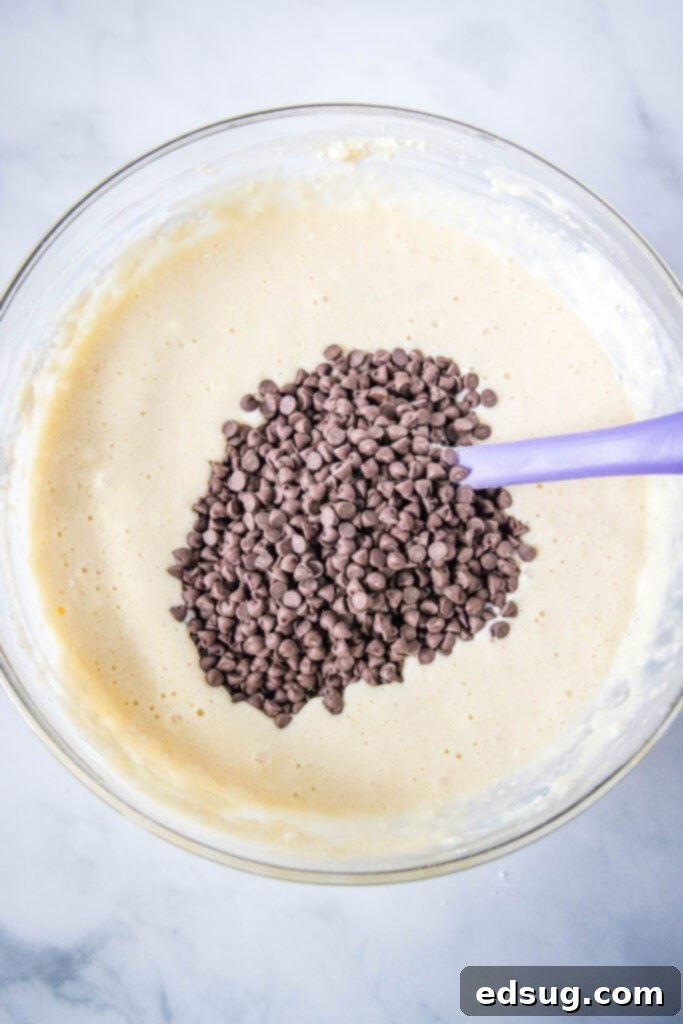 Decadent Chocolate Chip Waffles 4 adding chocolate to waffle batter