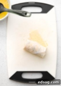 Canyon Crunch Rolls 11 rolled up egg roll on cutting board