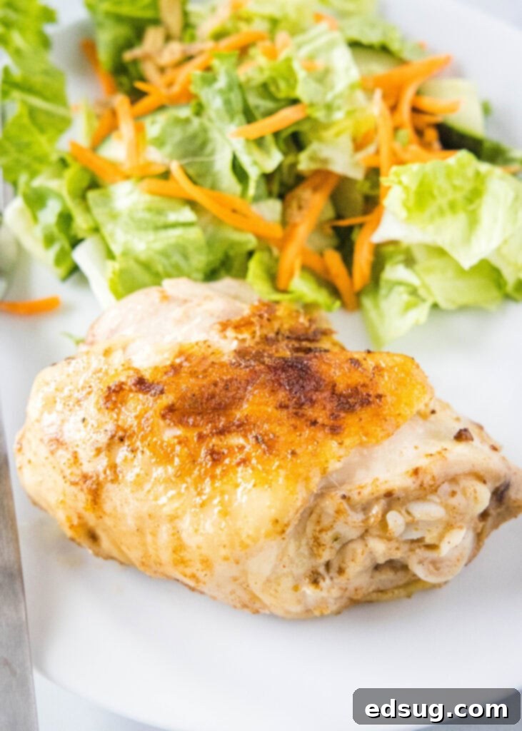 seared chicken thigh in a plate with salad