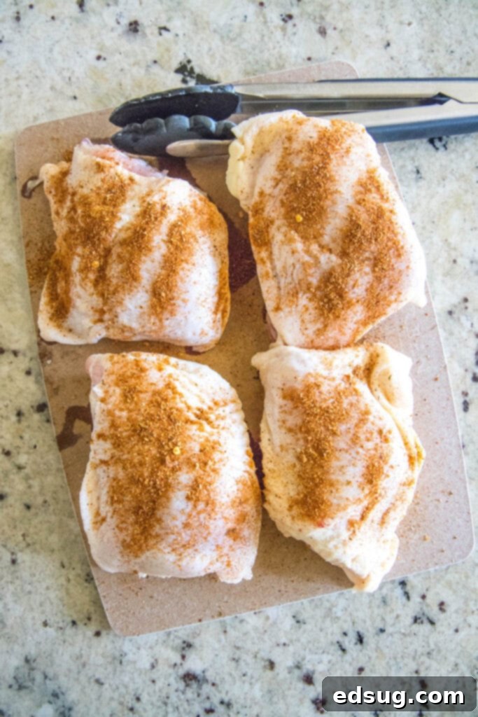 seasoned chicken thighs on a cutting board