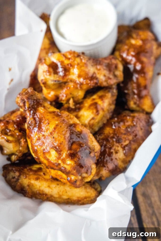 chicken wings in a basket with ranch dipping sauce