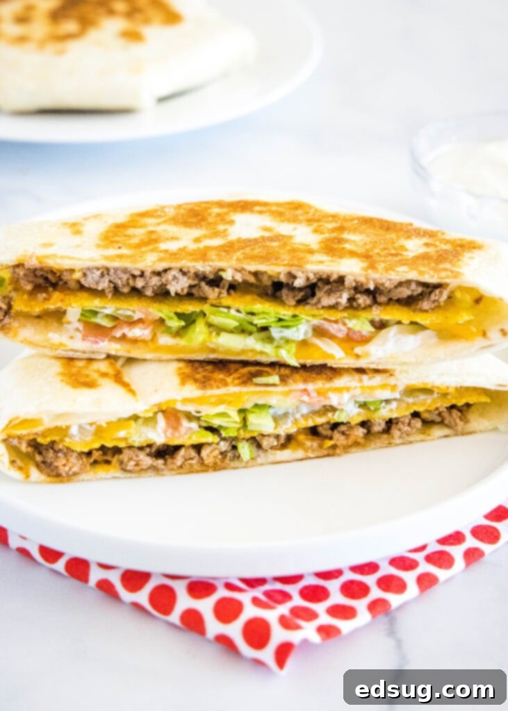 Ultimate Crispy Wrap 4 Crunchwrap cut in half on a plate showing perfect layers