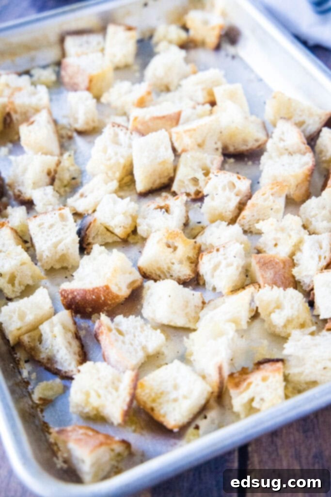 Crispy Homemade Croutons 5 Close-up of golden brown, baked bread cubes on a baking tray, perfectly crispy