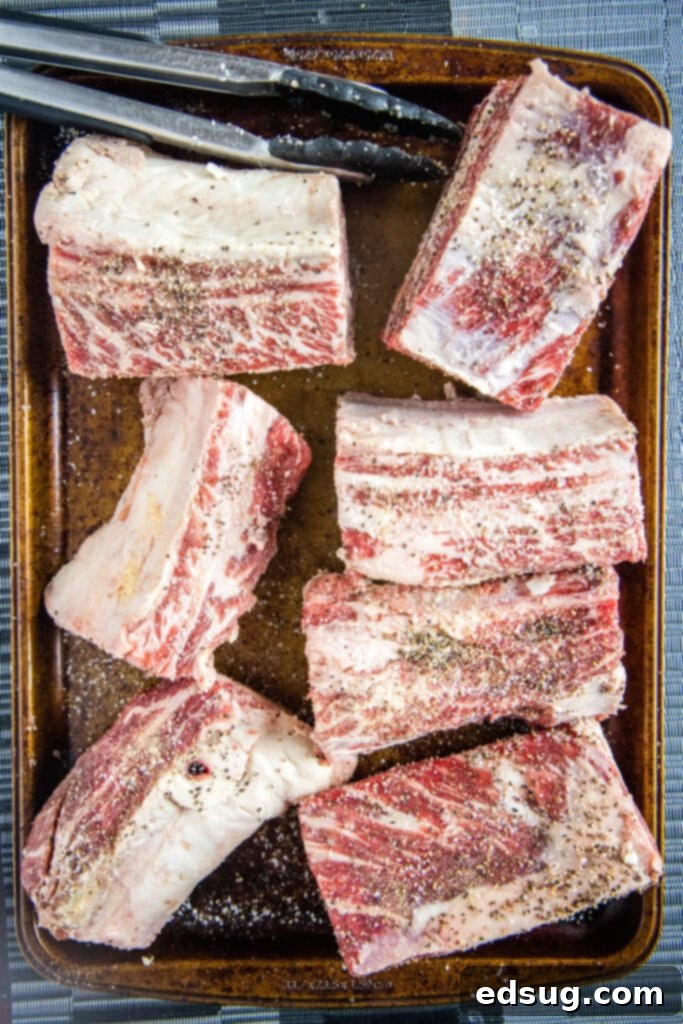 Pitmaster's Smoked Beef Short Ribs 4 seasoned beef short ribs on a baking tray