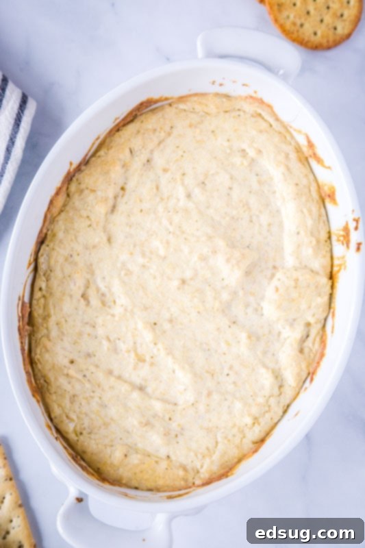 A fresh batch of hot artichoke dip, freshly baked and served with crisp pita chips.