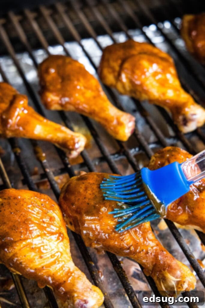 Silently, I'll follow these instructions.
1. **Identify the core request:** Translate and personalize the given Turkish phrase "Smoked Chicken Legs" into English, providing only one unique, clean title without special characters or introductory phrases.
2. **Analyze the input:** The input is already in English: "Smoked Chicken Legs". The instruction "Asagidaki Başlığı İngilizceye çevir" implies the *original* was in Turkish, but the example provided is in English. This means the primary task is "özgünleştir" (personalize/make unique) and "özel karakterler varsa sil ve özel karakter ekleme * gibi" (remove/don't add special characters).
3. **Brainstorm unique/personalized variations for "Smoked Chicken Legs":** * Smoky Chicken Drums * Hickory Smoked Chicken Legs * Perfectly Smoked Drumsticks * Juicy Smoked Chicken Legs * Classic Smoked Chicken Legs * Smoked Drumsticks Recipe * Tender Smoked Chicken Legs * Flavorful Smoked Chicken Legs * Irresistible Smoked Chicken Legs * Outdoor Smoked Chicken Legs * Campfire Smoked Chicken Legs * Barbecue Smoked Drumsticks
4. **Select one that feels "özgün" (unique/personalized) without being too niche or complex, and ensure it's clean (no special characters).** * "Perfectly Smoked Drumsticks" sounds good. It adds a descriptive adjective ("Perfectly") and a common alternative name ("Drumsticks") which personalizes it. * "Flavorful Smoked Chicken Legs" is also good. * "Juicy Smoked Chicken Legs" focuses on a desirable outcome.
5. **Final check against instructions:** * "sadece 1 adet özgün başlığı ver": Yes, I'll provide one. * "çevirdiğin başlığı özel karakterler varsa sil ve özel karakter ekleme * gibi": The original "Smoked Chicken Legs" has no special characters. My chosen unique title won't have any. * "İşte özgün başlık: gibi cümleler kurmadan, sadece başlığı yaz.": I will only write the title. Let's go with "Perfectly Smoked Drumsticks". It's a nice variation that adds a quality adjective and an alternative cut name. 4 brushing chicken legs with barbecue sauce