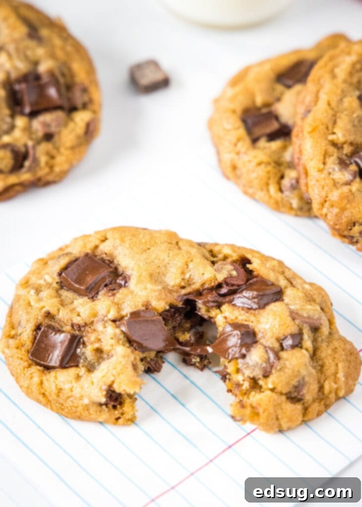 Copycat Chick-fil-A Chocolate Chunk Cookie Recipe 2 A freshly baked Chick-fil-A copycat cookie broken in half, revealing gooey melted chocolate chunks and a soft, chewy interior.