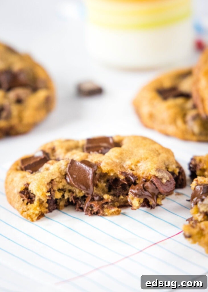 Copycat Chick-fil-A Chocolate Chunk Cookie Recipe 5 A close-up shot of the inside of a warm cookie, showcasing incredibly gooey, melted chocolate chunks.