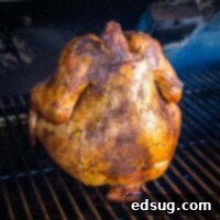 The Ultimate Smoked Beer Can Chicken 7 close up smoked beer can chicken on the smoker