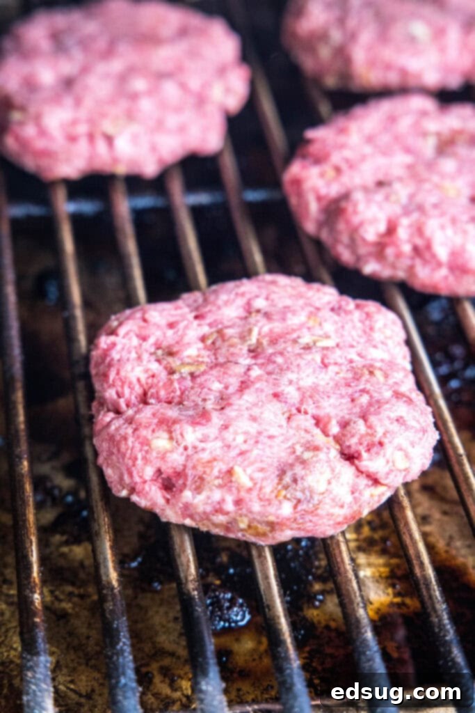 uncooked hamburgers on the smoker