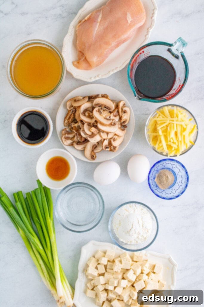 Essential ingredients laid out for preparing a delicious Hot and Sour Soup, showcasing fresh mushrooms, tofu, and sauces.