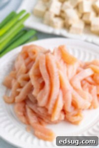 raw chicken strips on a plate
