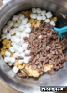 Smores Cookies 8 cookie dough in a mixing bowl with chocolate and marshmallows on top