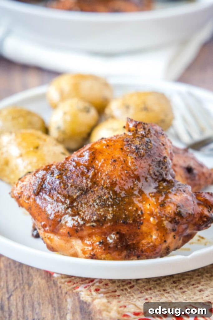 smoked chicken thigh on a plate with potatoes