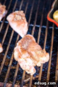 putting seasoned chicken thighs on the smoker