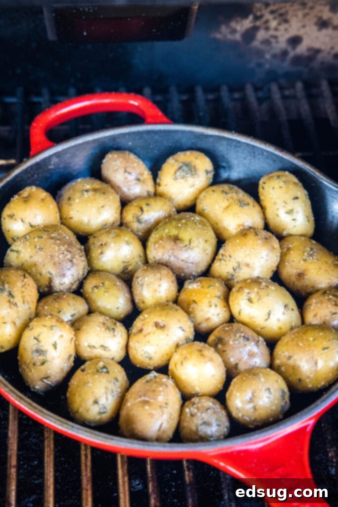 a pan of potatoes on the smoker