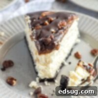 close up slice of turtle cheesecake with bite on a fork