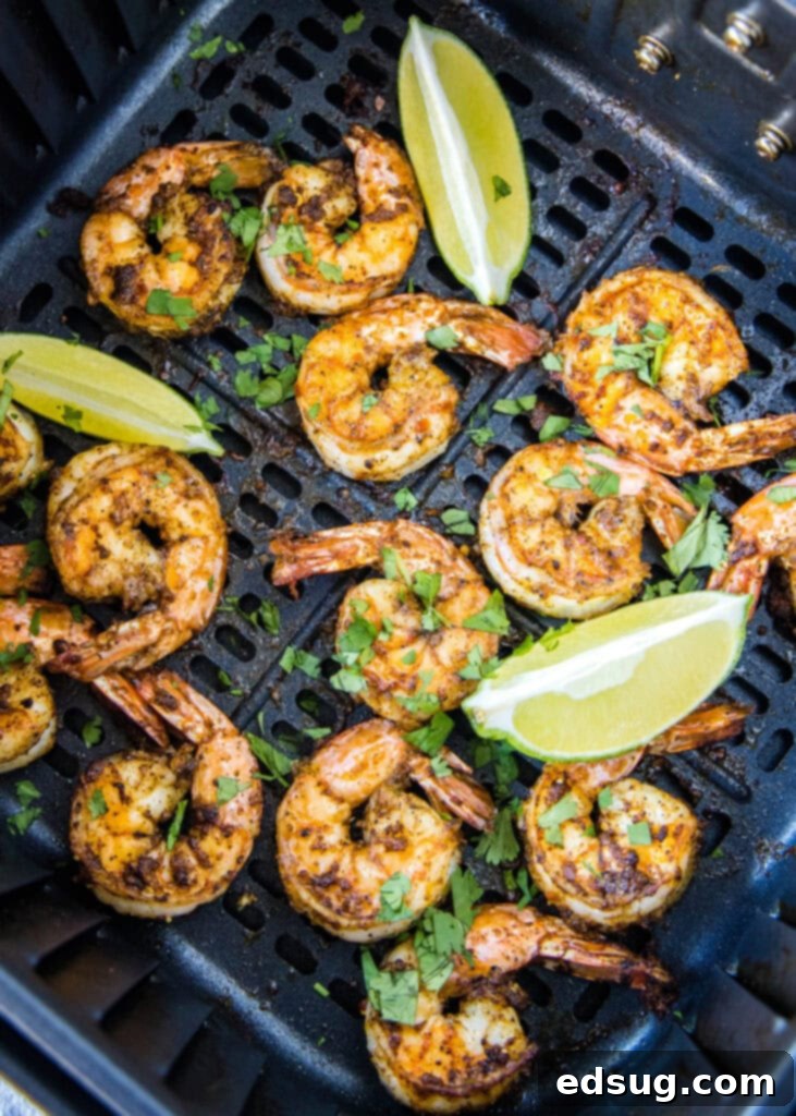 Crispy Air Fryer Shrimp 2 Perfectly cooked air fryer shrimp sprinkled with fresh cilantro and served with lime wedges, ready to eat.