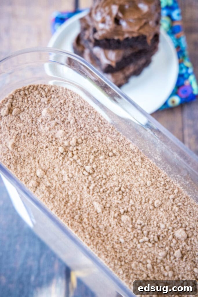 Craft Your Own Brownie Magic 5 container of brownie mix with plate of brownies in the background