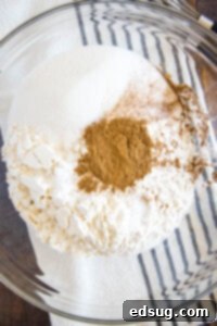 Spiced Pumpkin Waffles 8 Dry ingredients like flour, sugar, spices, and leavening agents in a large bowl, mixed together for pumpkin waffles.