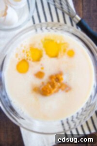 Spiced Pumpkin Waffles 9 Wet ingredients including buttermilk, eggs, pumpkin puree, and melted butter in a separate bowl, whisked until smooth.