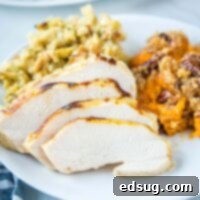 Juicy Sous Vide Turkey Perfection 8 close up of sliced turkey on a plate with sweet potatoes and stuffing