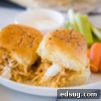 Close-up of Buffalo Chicken Sliders on a white plate with ranch dressing