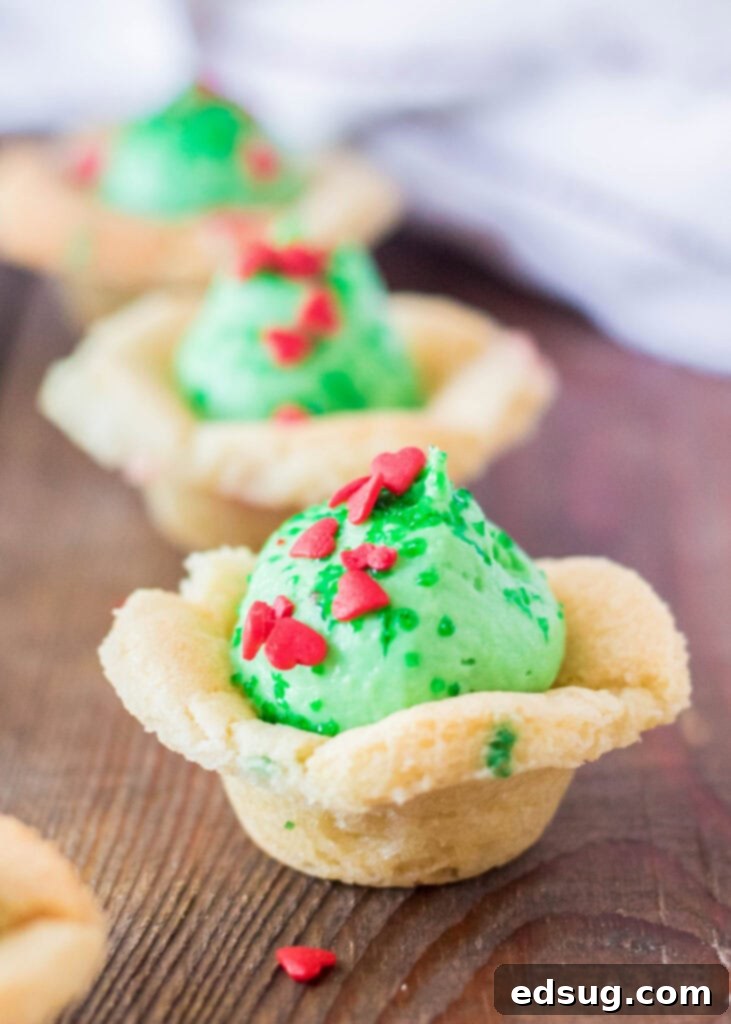 Grinchmas Sugar Cookie Bites 2 sugar cookie cups topped with green no bake cheesecake