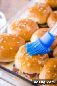 brushing butter on french dip sliders